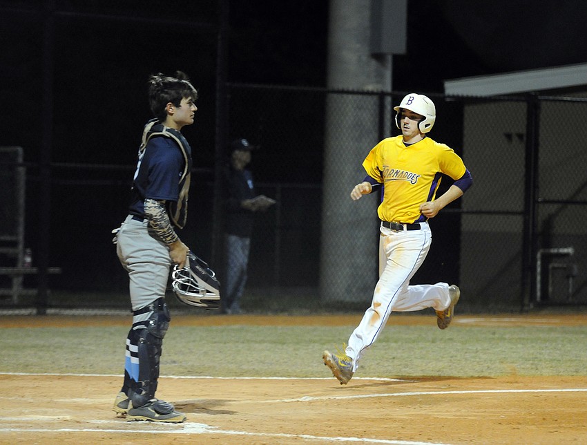 Booker's Micah Davis touches home plate in the first inning.