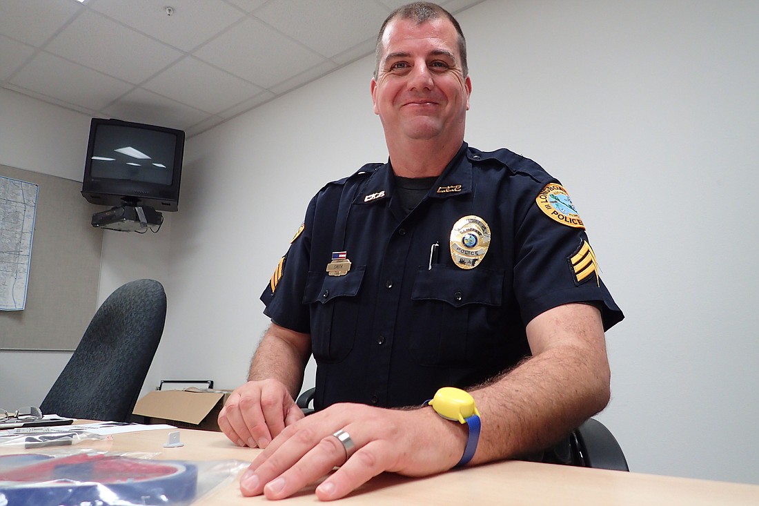 Longboat Key Police Sgt. Lee Smith shows off a Project Lifesaver bracelet outfitted with a transmitter.