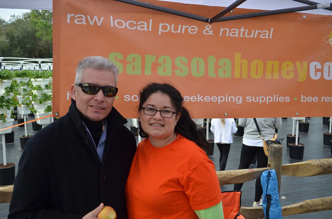File photo. Sarasota Honey Company owners Glen and Alma Johnson  at the grand opening of Sweetgrass farms in January 2015 to celebrate the partnership that helped lead to the upcoming Honey Bee Festival.