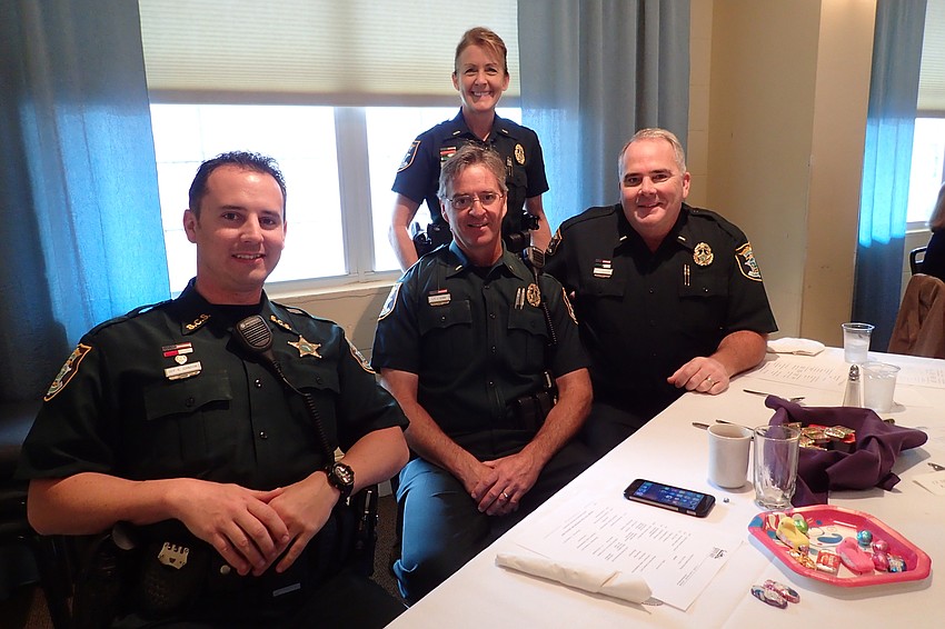 Deputy Rick Johnson and Lieutenants Jim Quinn,  Charlie Kaspar and Debra Kaspar (standing)