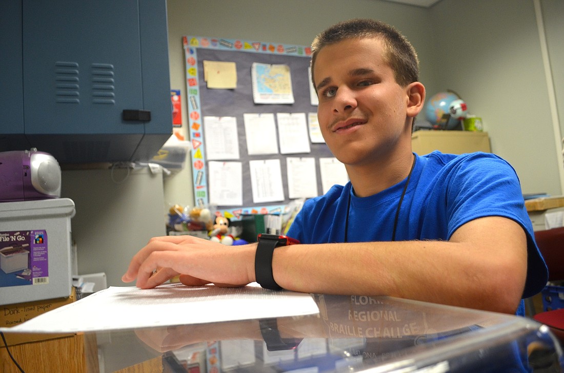 Brandon Cox uses Braille to read his assignments for classes.