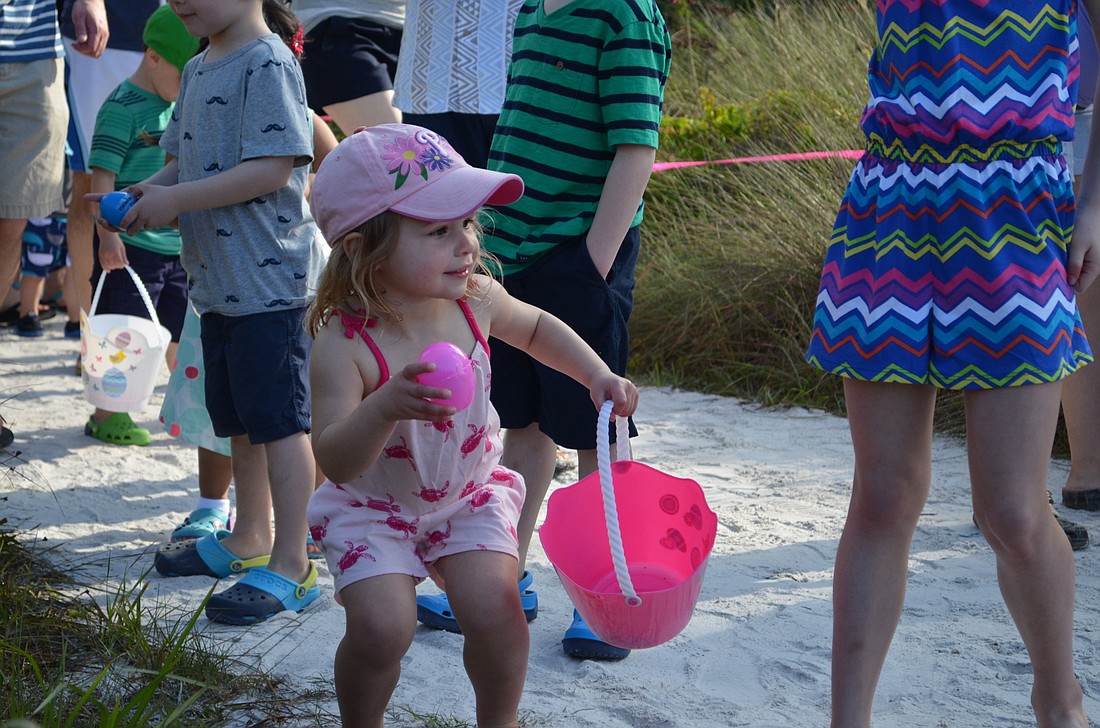 Megan Magee finds an Easter egg hidden along the trail at Beach Access #5.