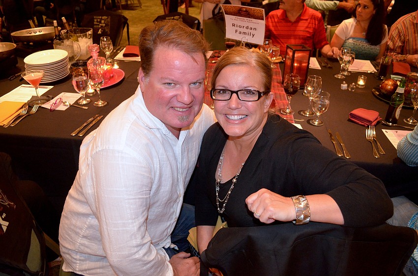 Bob James and Beth Miller cozy up at a table with family and friends.