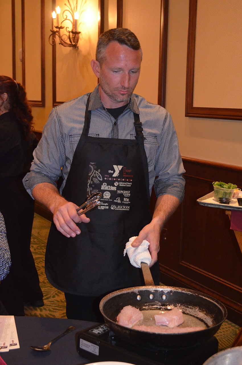 Rob Rowe cooks fish for his table.