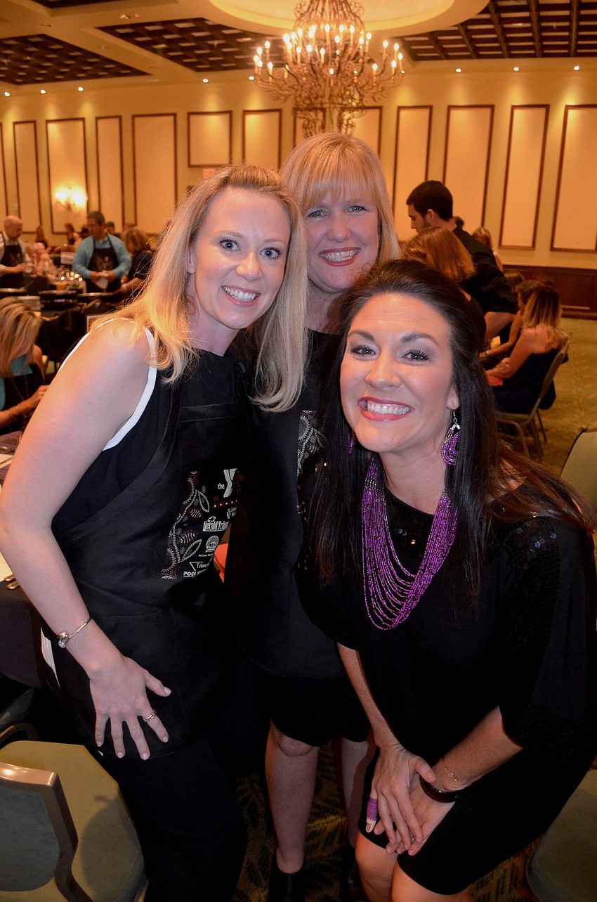 Anna Sofia Hait, Karen Fletcher and Maggie Segneri joke around while their table mates cook dinner.