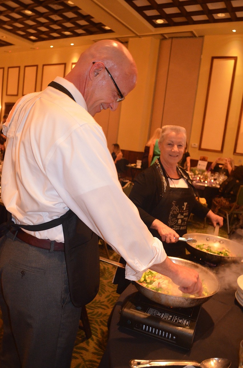 Mike Arrigo adds some seasoning to his dish.