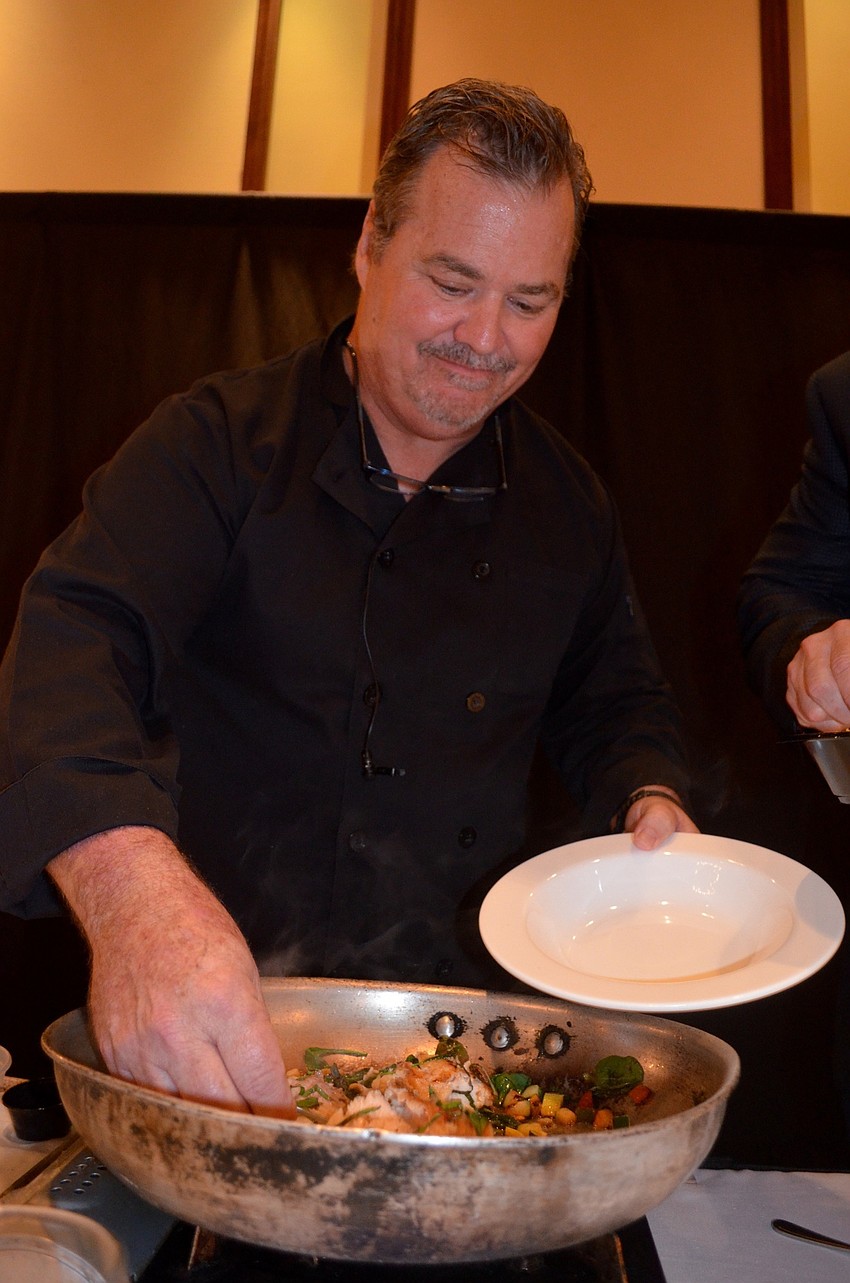 Tommy Klauber, owner of Polo Grill and Bar, plates his dish — salmon and couscous.