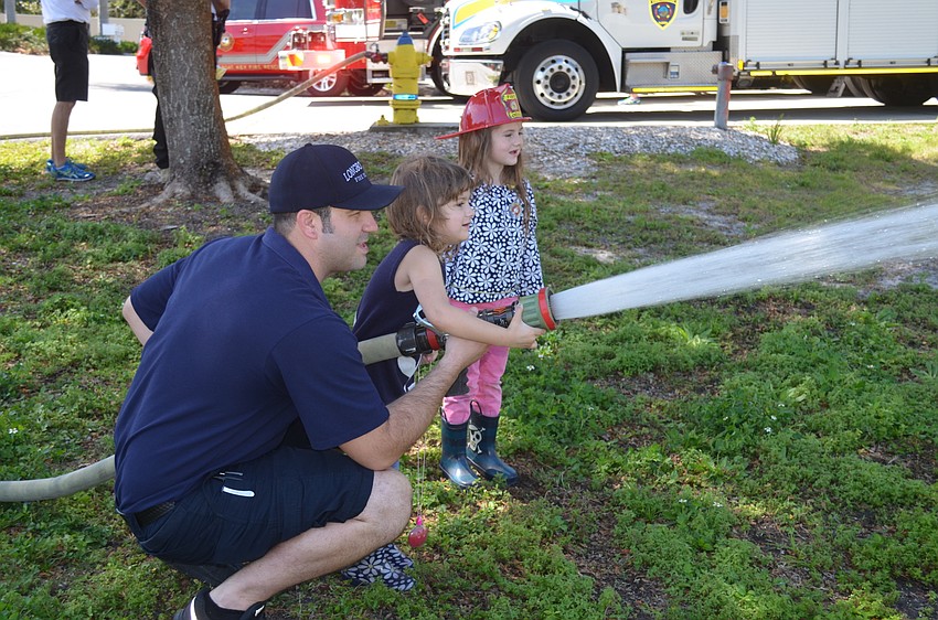 Firefighter/paramedic Ryan Ravelo with Alahna and Lexi Gwen Smith