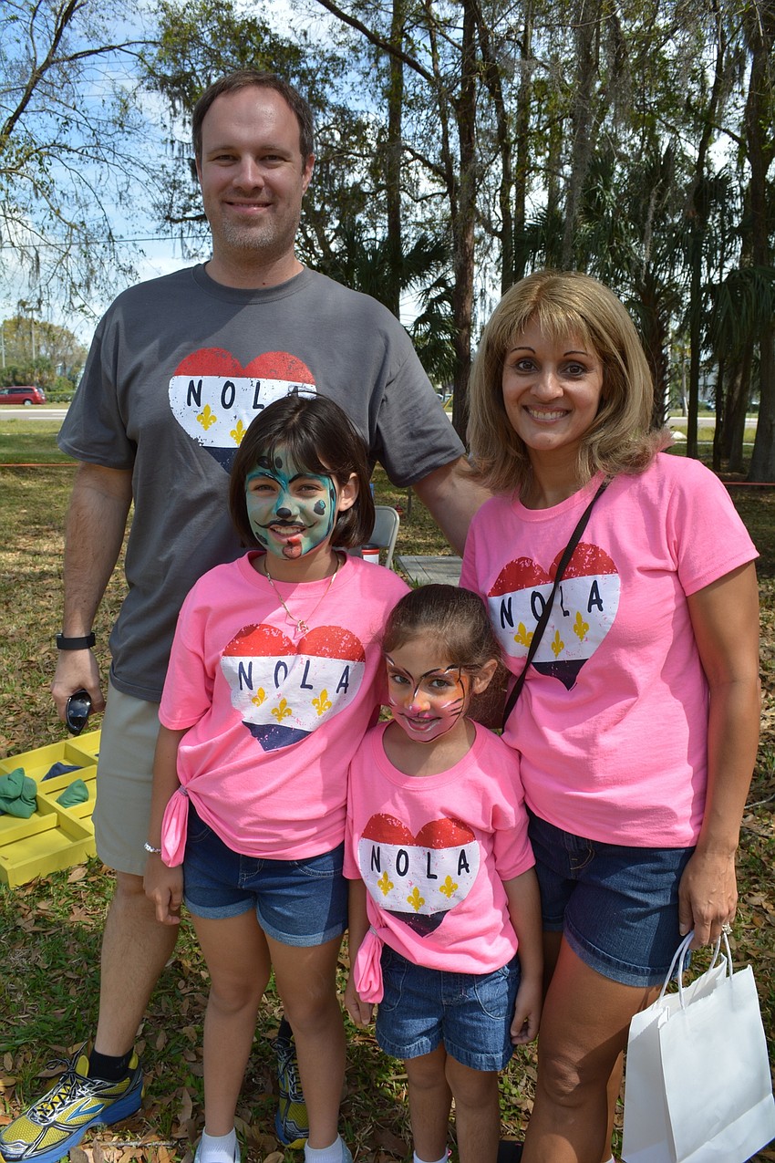 Heritage Harbour residents Sean and Nadia Wood and their daughters,  Hannah, left front, and Haven, right front, enjoy the day together.