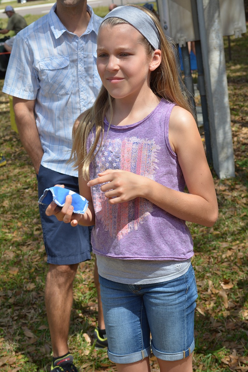 Sarah DiPasquale, a student at Haile Middle School, tries her hand a bean bag toss game.
