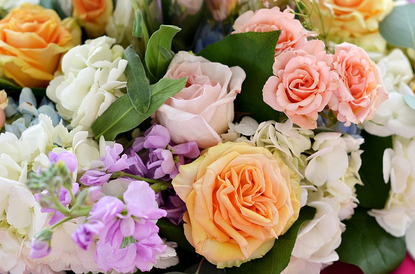 Fresh flowers surrounded champagne buckets on the tables at Pique Nique