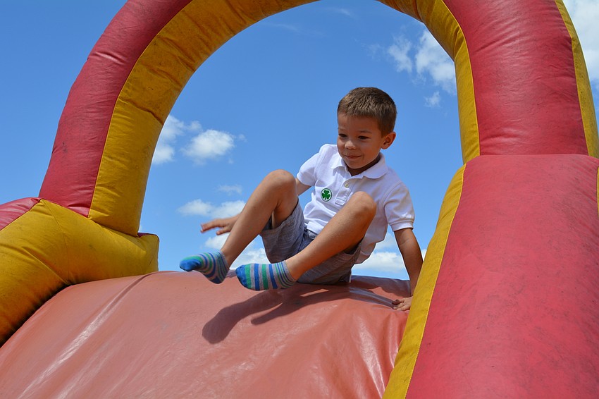 East County resident Tobin Heyman, 6, tackles an inflatable obstacle course.
