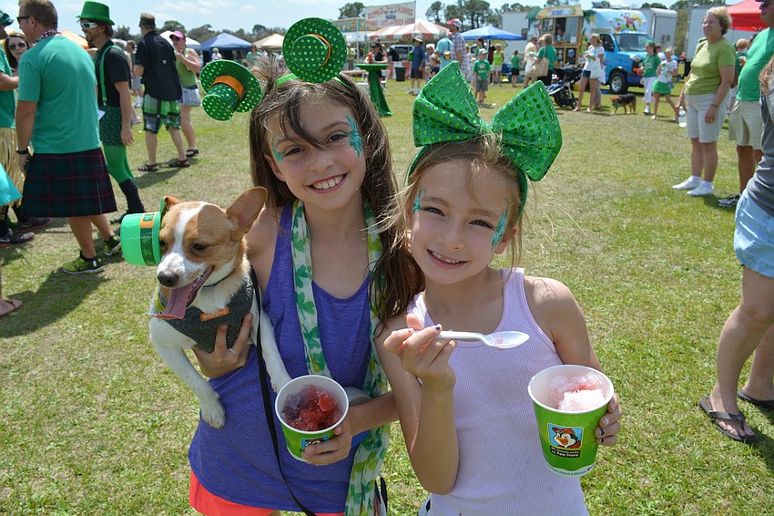 Braden River Elementary students Emma Dawson an Isabella Bennett have fun together. Emma brought her puppy, Chase.