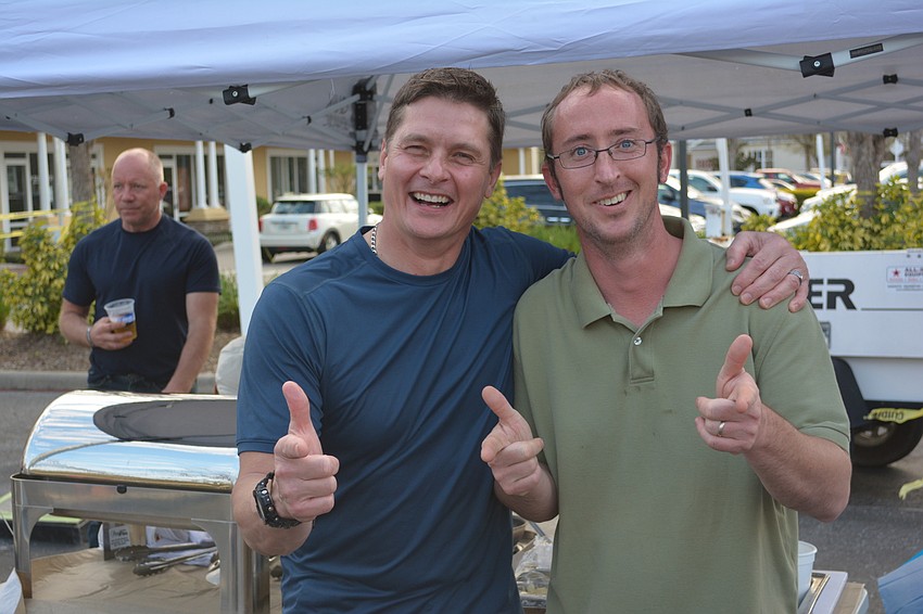 John Breimer, the owner of Wolf's Head Pizza & Wings, enjoys the Heroes Party at the Ranch with Scrambled owner Joel Henderson. The two business owners were sponsors of the event.