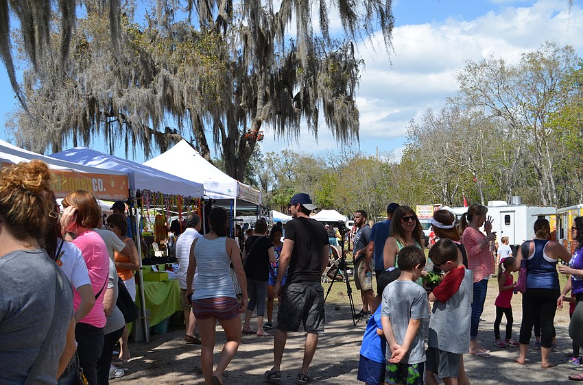 Vendors and artists line the path at the Honey Bee Festival Saturday, March 12.