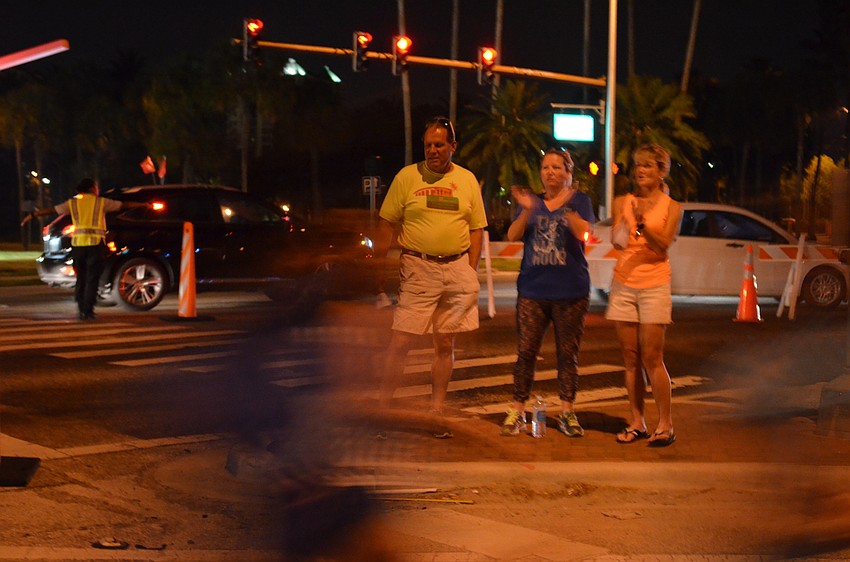 Chris Common, Hillary Maher and Cindy Common woke up early to cheer runners on at the intersection of Gulf Stream and Tamiami Trail.