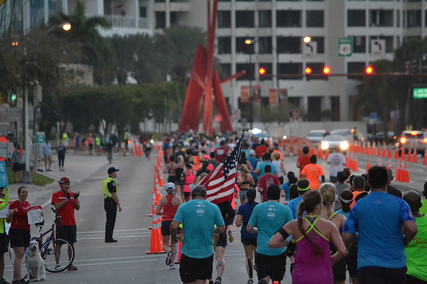 Runners make their way down the John Ringling Bridge.