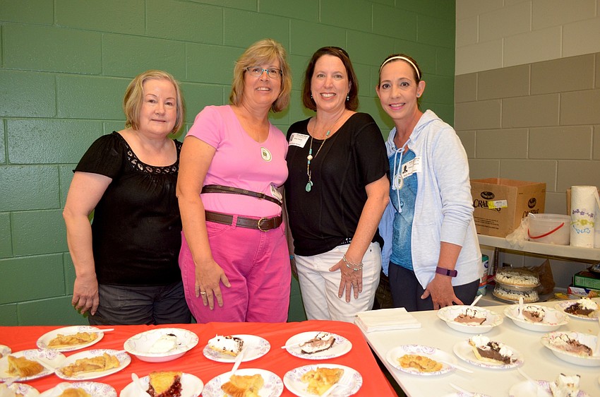 Volunteers Paula Siegel, Bonnie Golon, Shea Haupt and Nitza De Jesus dished out pie Nolan Middle students' parents donated for the event.