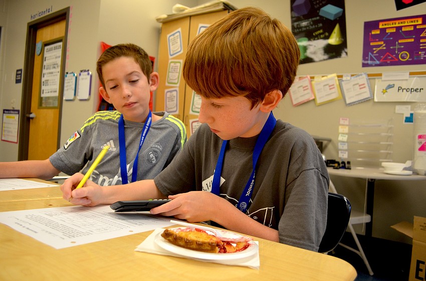 Joseph Baumeister and T.J. Bellaire enjoy two forms of Pi and pie during math class at Nolan.