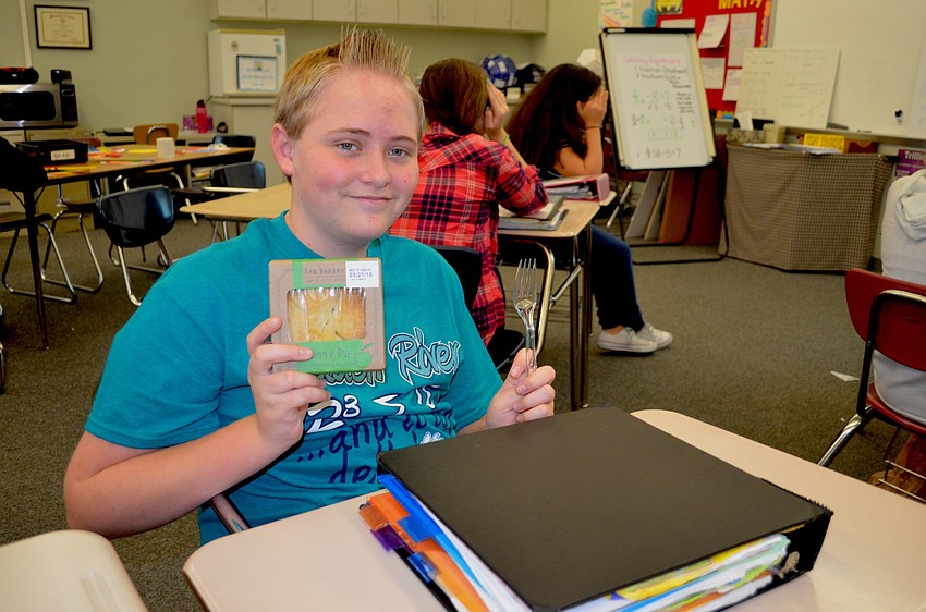 Cameron Root shows off the apple pie he plans to eat after he solves a Pi equation in his Braden River math class.
