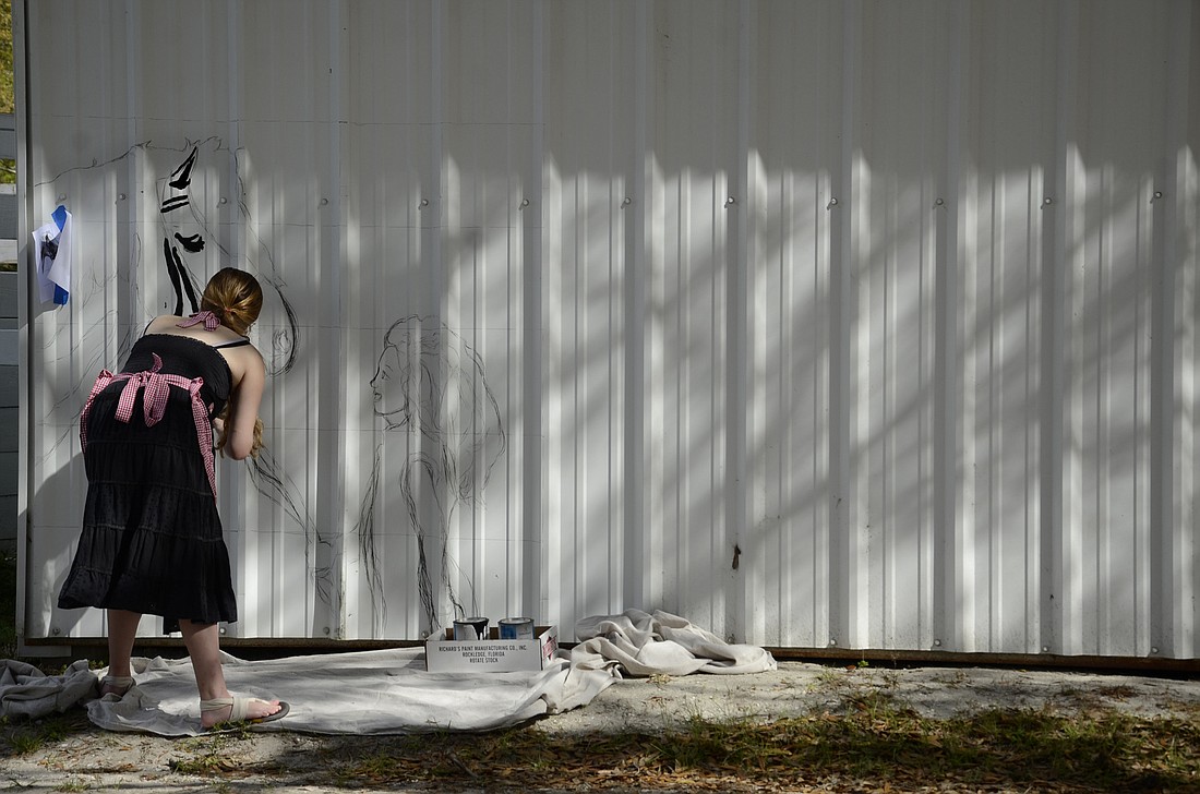 Natalie Palumbo, a 21-year-old student at Ringling College of Art and Design, begins a mural of a pony and a young girl as part of a project for Sarasota Manatee Association for Therapy Riding.
