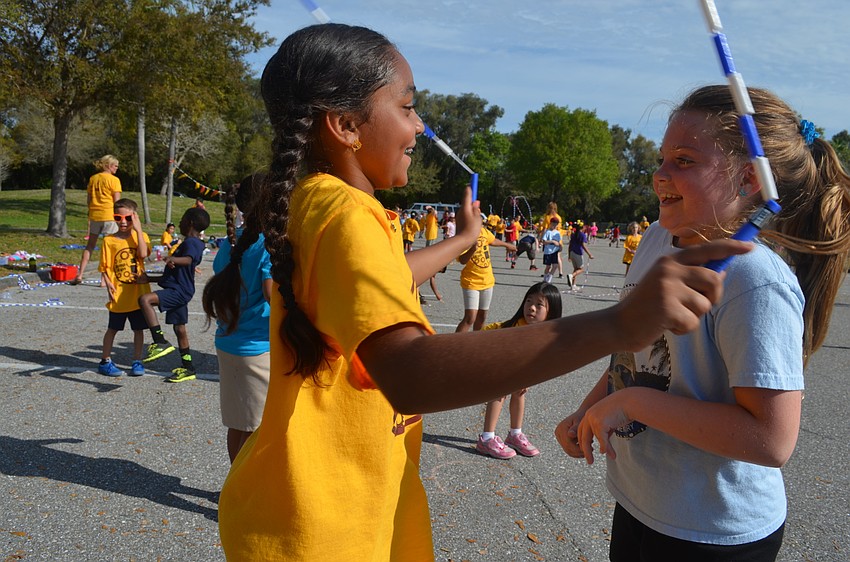 Jaelah Alexander and Alexis Huffstutler share laughs and a jump rope.