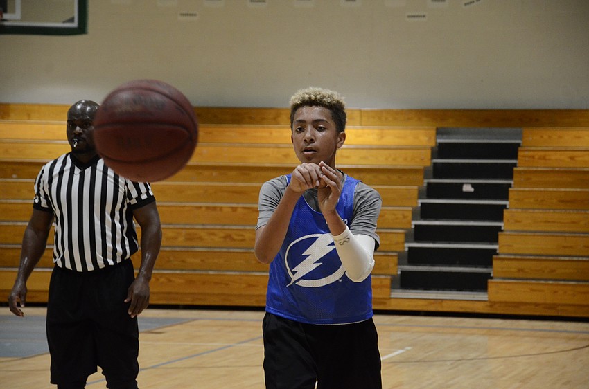 Xavier Williams passes the ball.