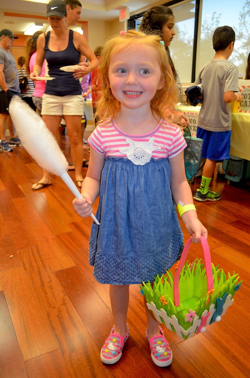 Three-year-old Raine Allen enjoys cotton candy.