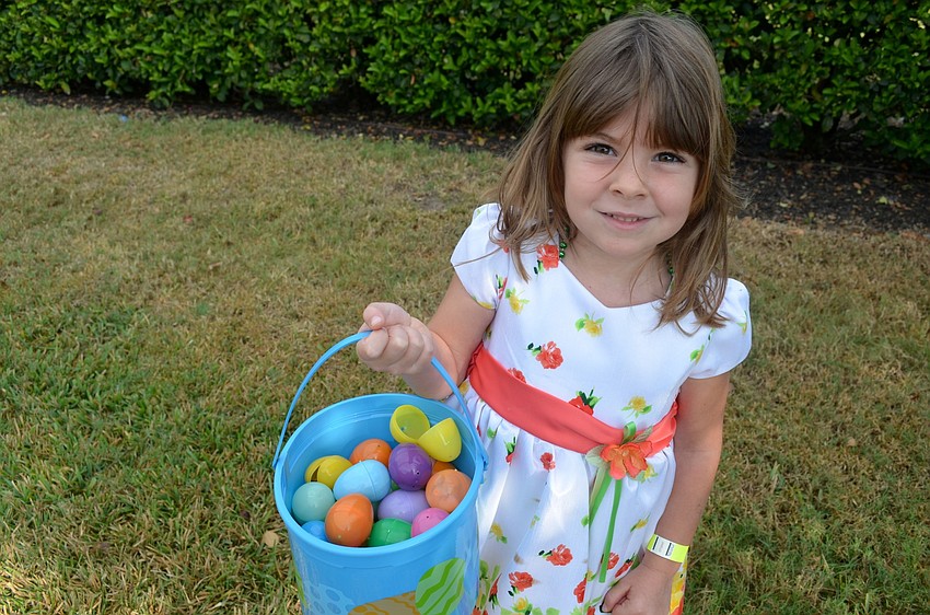 Four-year-old Lola Gostel has a full basket of eggs.