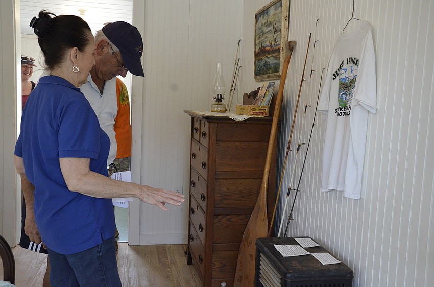 Yvonne Bedell talks with Bob Dallensandro, both of the Friends of the Braden River, about the historic fishing poles they had found to include in the replica historic cabin.