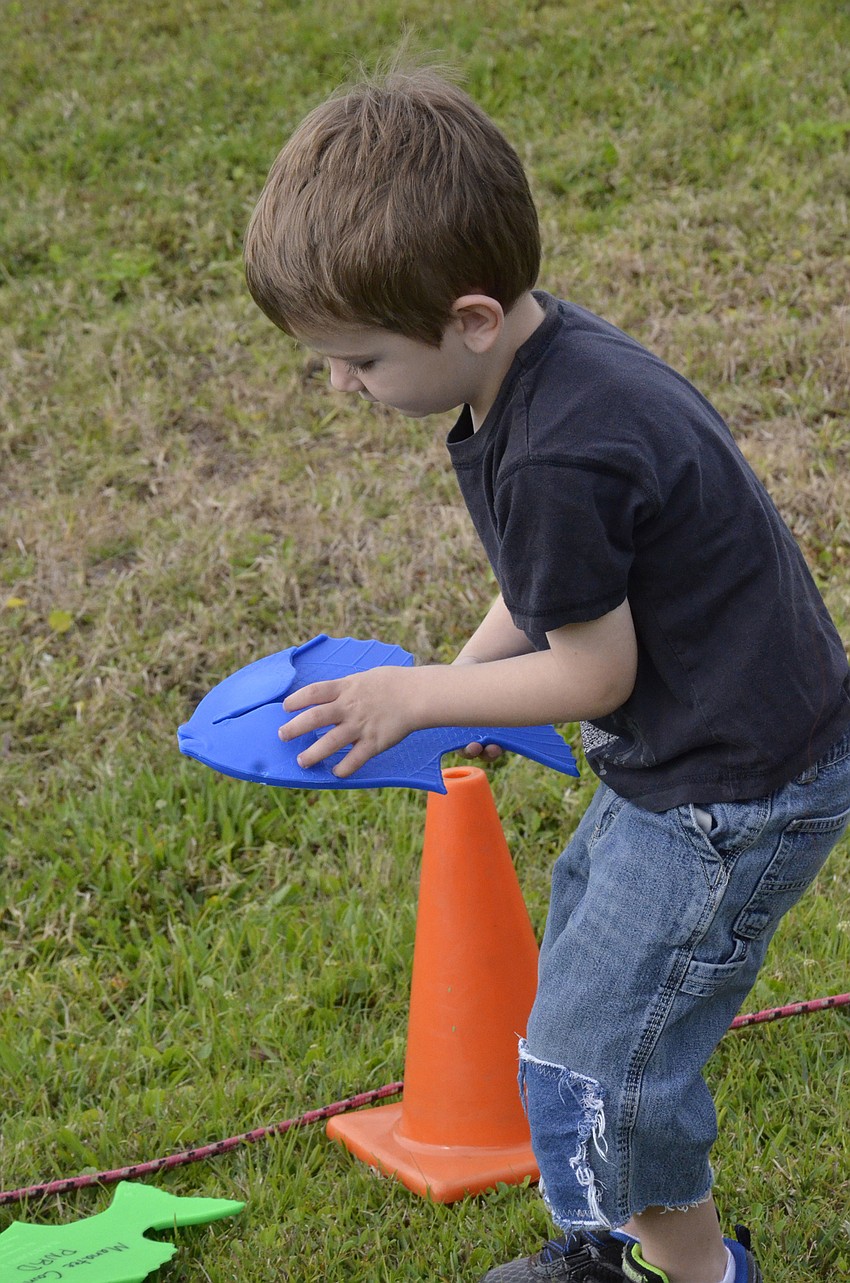 Joshua Coblentz the Second of East Bradenton examines his catch.