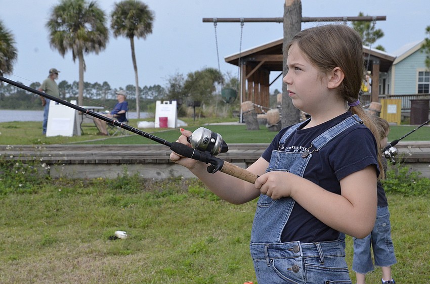 Lillian Coblentz tries to hook a plastic fish at the festival.