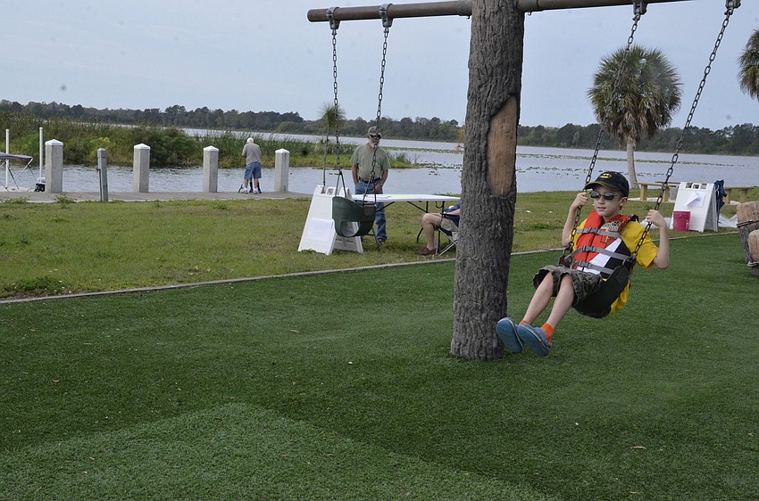East County resident Aaron Elliott waits for his grandmother, Sara Zavos. Zavos brought her grandson because she heard about the festival and also wanted to take him out kayaking.