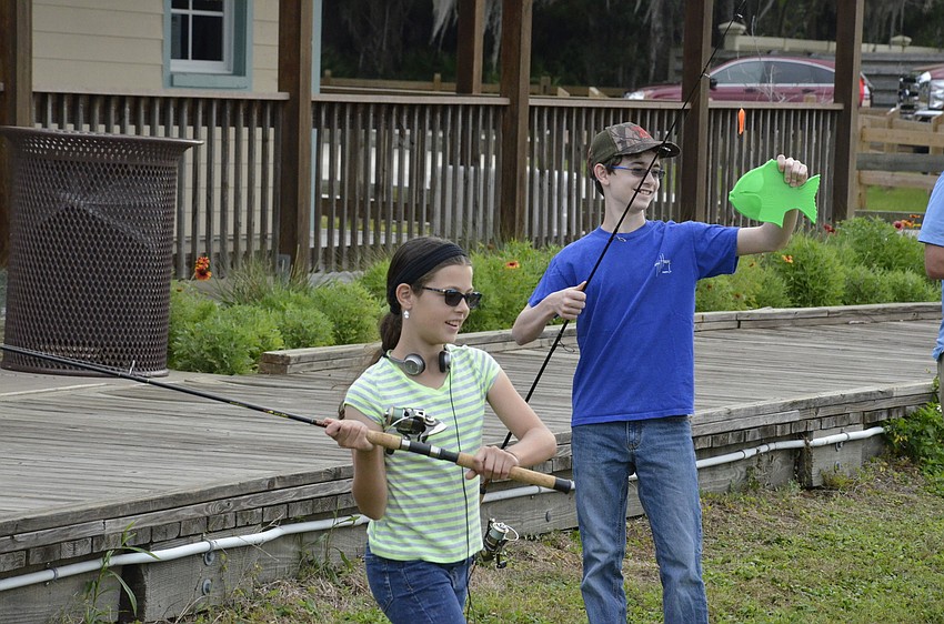 East Bradenton residents Danica and Dylan Schmucker practice their casting skills.