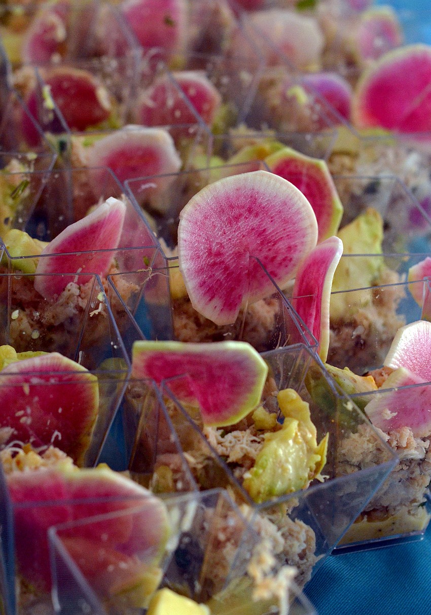 Crab and avocado salad dressed with golden raisin oregano vinaigrette, garnished with watermelon radishes by Hotel Indigo
