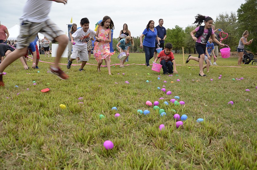Children run to collect eggs during the final hunt of Bayside Community Church's EGGolution.