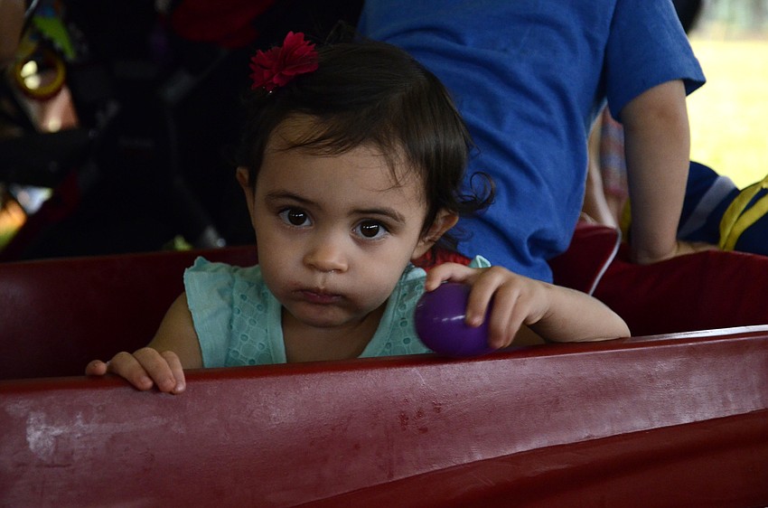 Olivia Fuller of Bradenton holds on dearly to her purple Easter egg.