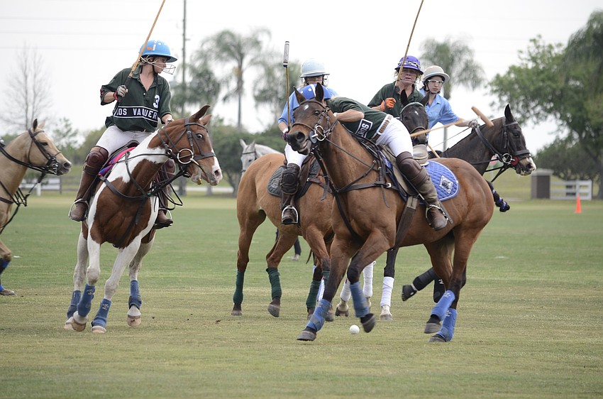 Kimberly Von Strode, left, assists a fellow team member on the Polo Grill team.