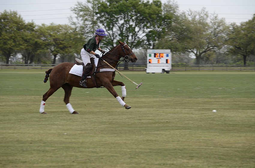 Morgan Bowman on the Polo Grill team drives the ball forward.