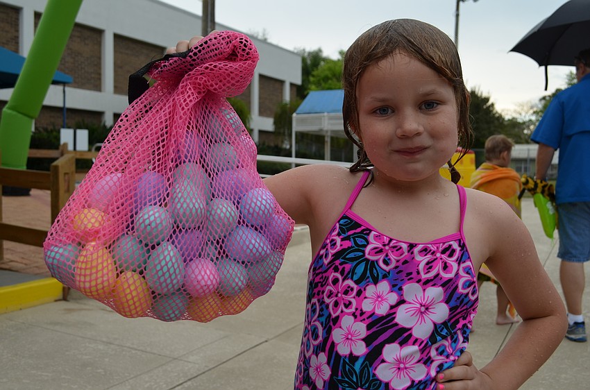 Ella Marchbank shows off her Easter eggs that she collected in the pool.