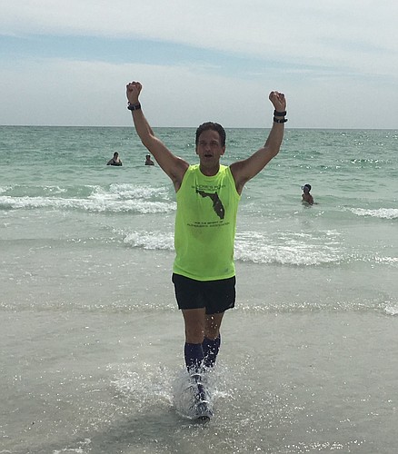 Steve Schwalbach finishes his run across Florida March 18, at Lido Beach. (Courtesy photo)