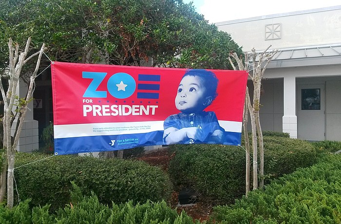 The sign's tagline reads, "From early education to career readiness, the Y gives kids like Zoe the support they need to be president...potentially...in like, 2064." Photo by Pam Eubanks.