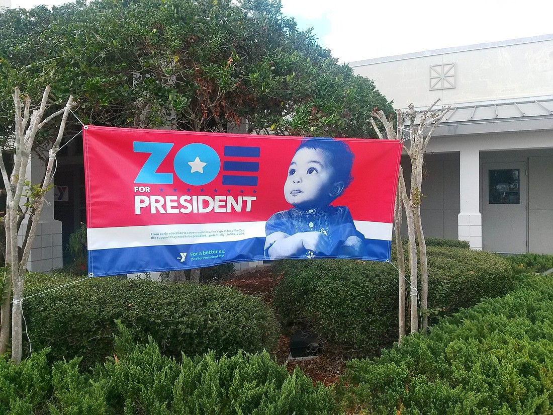 The sign's tagline reads, "From early education to career readiness, the Y gives kids like Zoe the support they need to be president...potentially...in like, 2064." Photo by Pam Eubanks.
