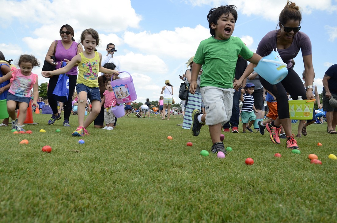 File photo. After an agonizing wait, kids at the 2015 Big Truck EGGstravaganza egg hunt were released onto the field.