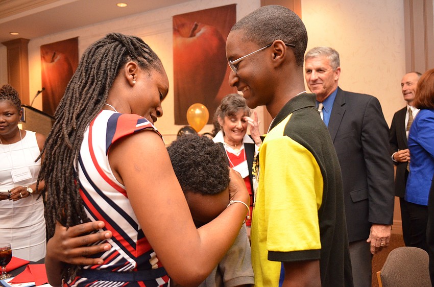 Teacher of the Year recipient Khea Davis celebrates the announcement with her sons Jayden and Kaleb Benony.