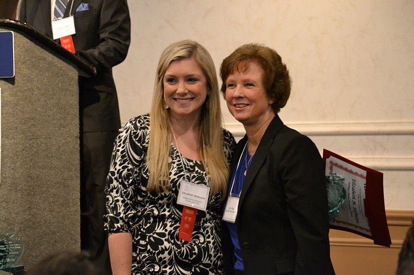 Phillippi Shores Elementary School fifth grade teacher Elizabeth Hofmann receives the Teacher of the Year award for her school from Superintendent Lori White.