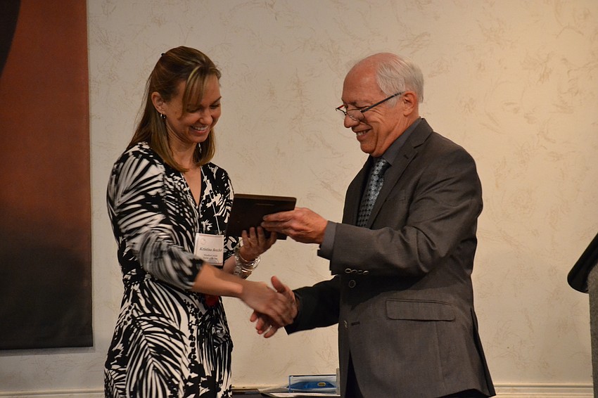 Teacher of the Year award for Woodland Middle School Kristina Beecher receives the award for being one of three finalists from Dick Steinman.