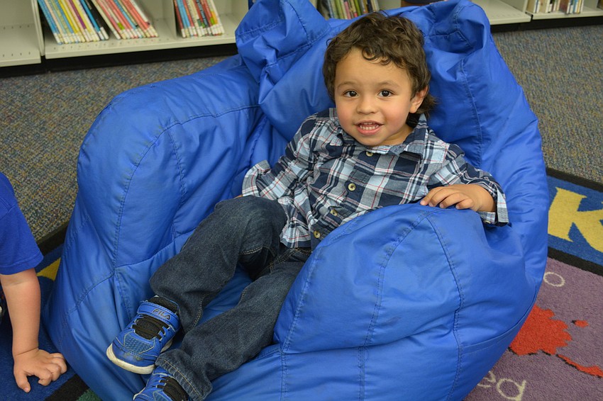 Antonio Disla Jr., 2, takes a rest after hunting for eggs.