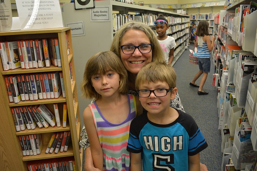 Christy Redcay, center, brings her grandchildren, Lorie, left, and Jacob, 6. Both are students at Gene Witt Elementary School.