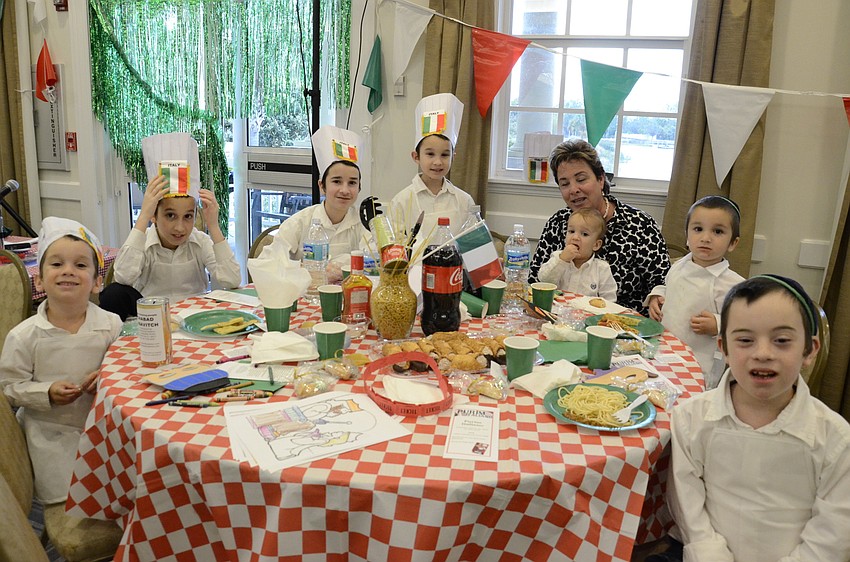 Bukiet brothers Shua, Mordechai, Chaim-Meir, Shay, Leible, Sholom-Ber and Zalman with their babysitter of 10 years, Allison Heitner